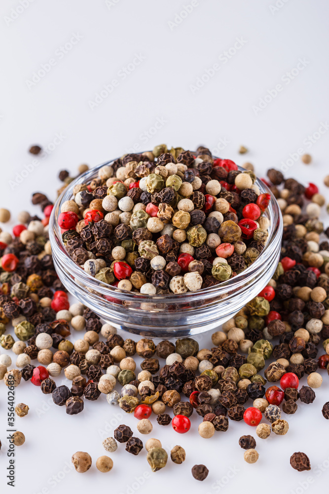 mix of peppercorns on white acrylic background mix of peppercorns on white acrylic background
