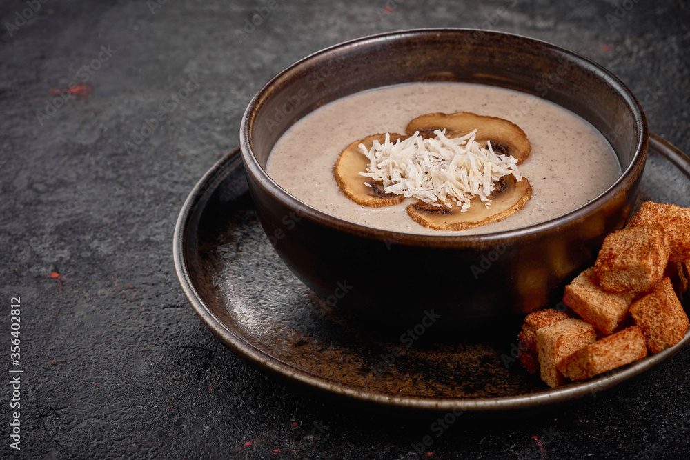 Creamy Mushroom Soup with crackers on the black background. Creamy Mushroom Soup with crackers on the black background.