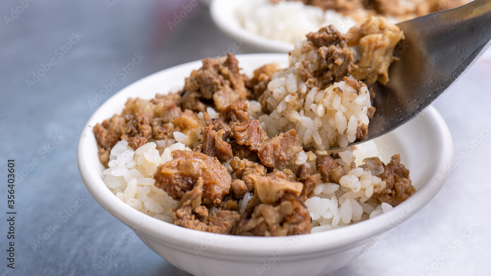 Braised meat rice, stewed beef over cooked rice in Tainan, Taiwan. Taiwanese famous traditional street food delicacy. Travel design concept, closeup. Braised meat rice, stewed beef over cooked rice in Tainan, Taiwan. Taiwanese famous traditional street food delicacy. Travel design concept, closeup.