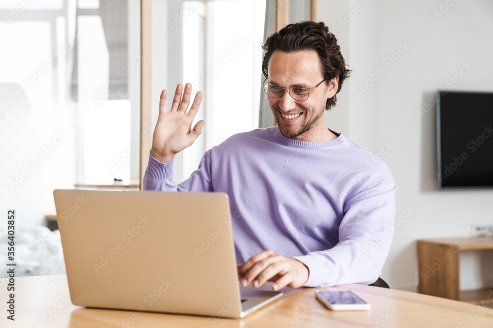 Attractive young man sitting at the kitchen table Attractive young man sitting at the kitchen table