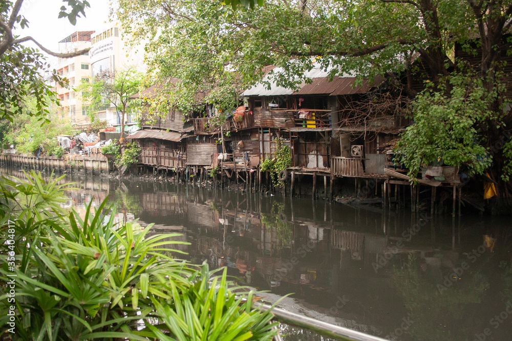 Poor and dirty hovels above the river in Bangkok suburban, Thailand