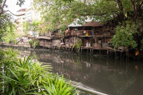 Poor and dirty hovels above the river in Bangkok suburban  Thailand