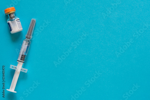 Diabetes. Diabetic coma. Glucagon. Hypoglycemia. Glucagon ampoule. Disposable syringe. A healthy lifestyle diabetic. Blue free background. Shymkent, Kazakhstan May 25, 2020