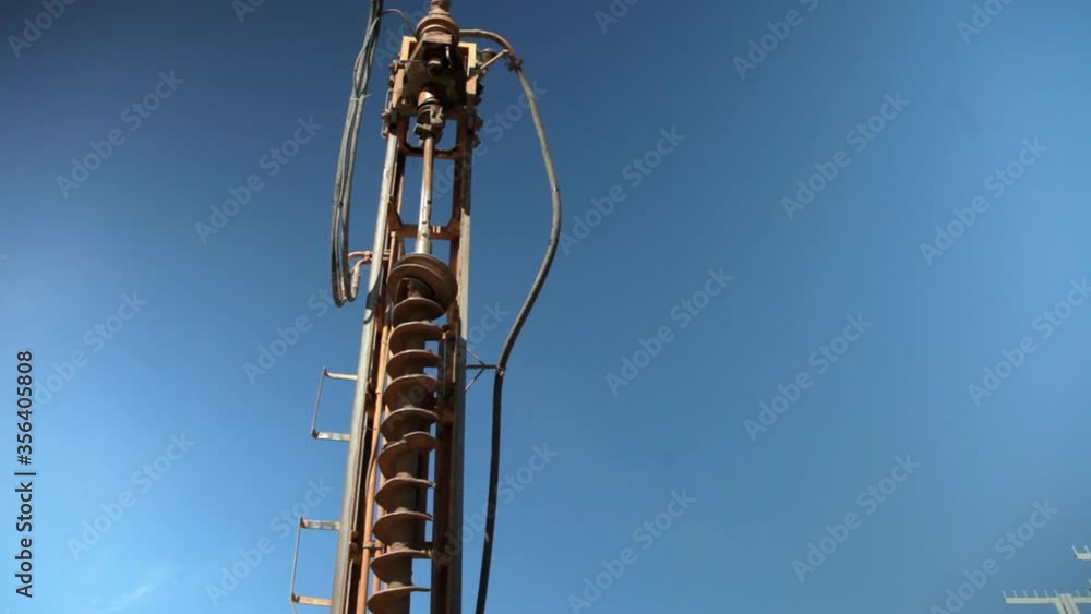 Water well drilling rig.Modern Rotary drill rig bore water well against the blue sky.Copy space. Water well drilling rig.Modern Rotary drill rig bore water well against the blue sky.Copy space.