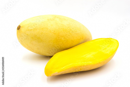 Ripe yellow mango fruit​ (Barracuda​ mango)​ with​ sliced​ isolated on​ white background