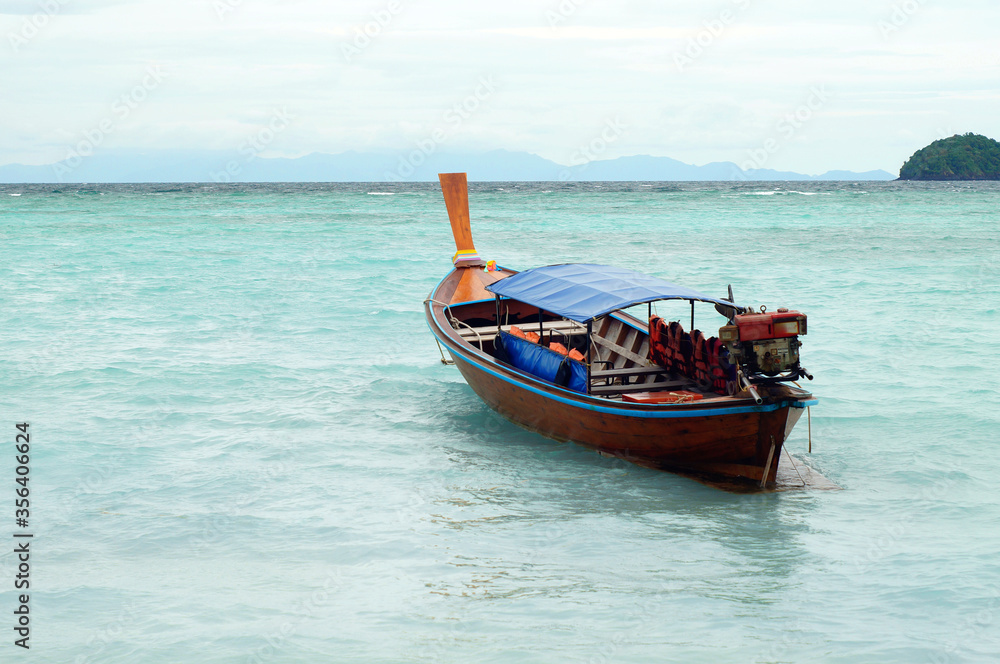 Tour boat parked on beach, tropical andaman sea ,Lipe island , Tarutao National Park, Satun, Thailand