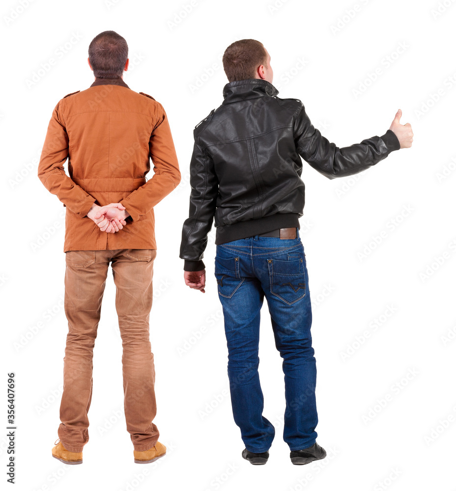 Back view of two man in winter jacket showing thumb up. Back view of two man in winter jacket showing thumb up.