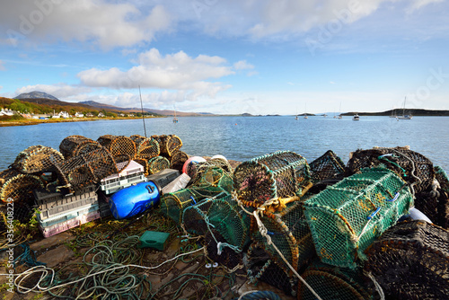 Fishing net and ropes close-up. Panoramic view of the valley near the mountain peaks (Paps of Jura) under the clear blue sky. Craighouse, Inner Hebrides, Scotland, UK. Traditional craft, food industry photo