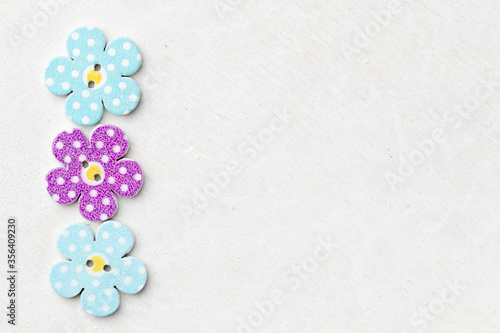 Creative background with decorative wooden buttons shaped like flowers
