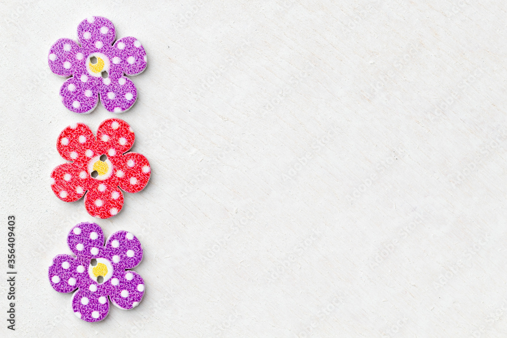 Creative background with decorative wooden buttons shaped like flowers Creative background with decorative wooden buttons shaped like flowers