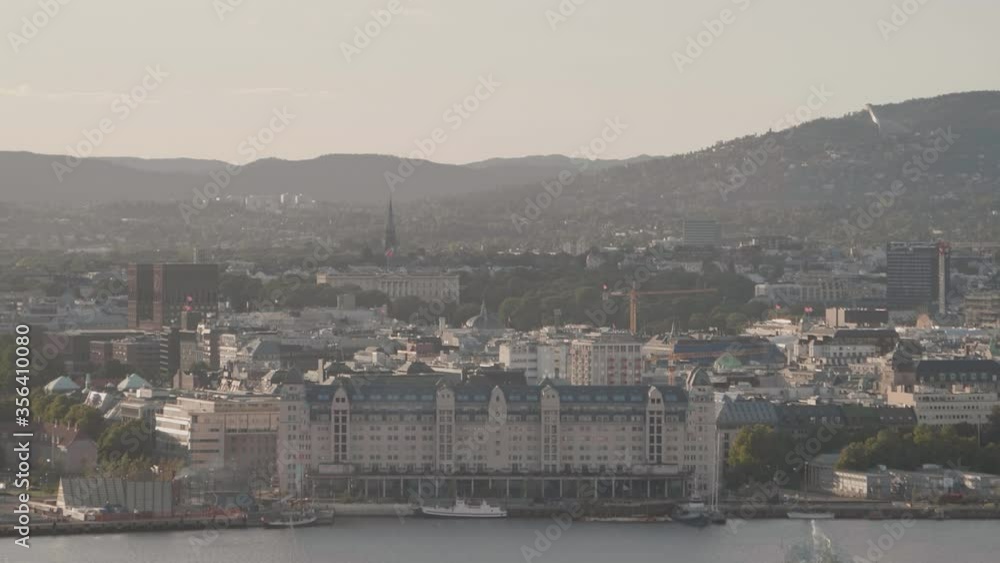 Handheld slow motion wide shot of Bjørvika fjord pier and parts of downtown city in evening sunlight, in Oslo Norway Handheld slow motion wide shot of Bjørvika fjord pier and parts of downtown city in evening sunlight, in Oslo Norway