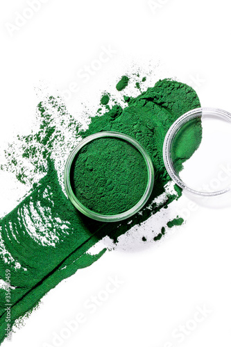 Organic green spirulina chlorella algae powder splash on white background photo