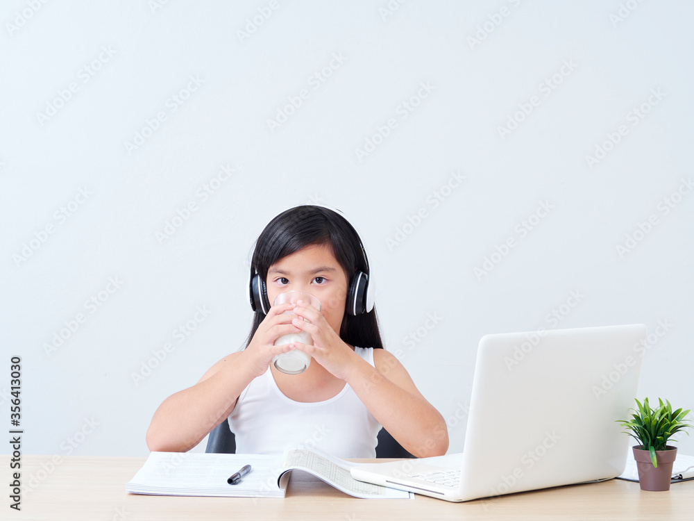 Schoolgirl drinking milk at home. Schoolgirl drinking milk at home.