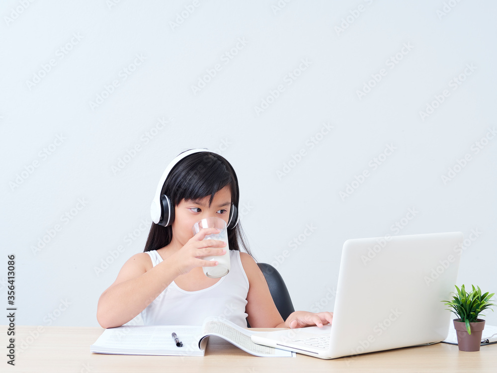 Schoolgirl drinking milk at home. Schoolgirl drinking milk at home.