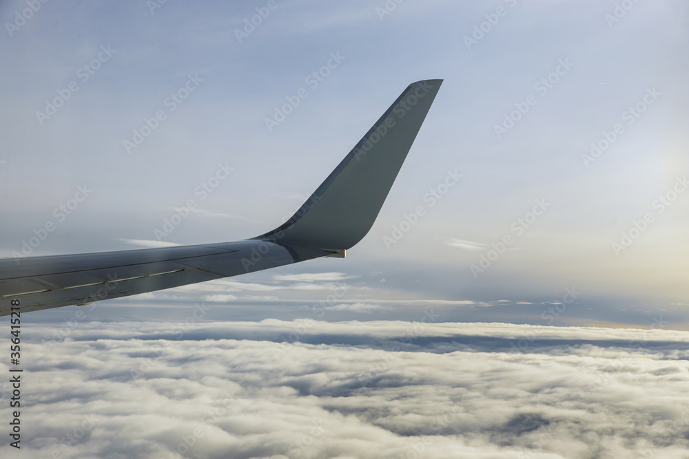 This time in altitude during aircraft wing on blue sky background. This time in altitude during aircraft wing on blue sky background.