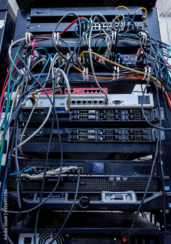 Server room with computers for internet. Network cables connected to switches.