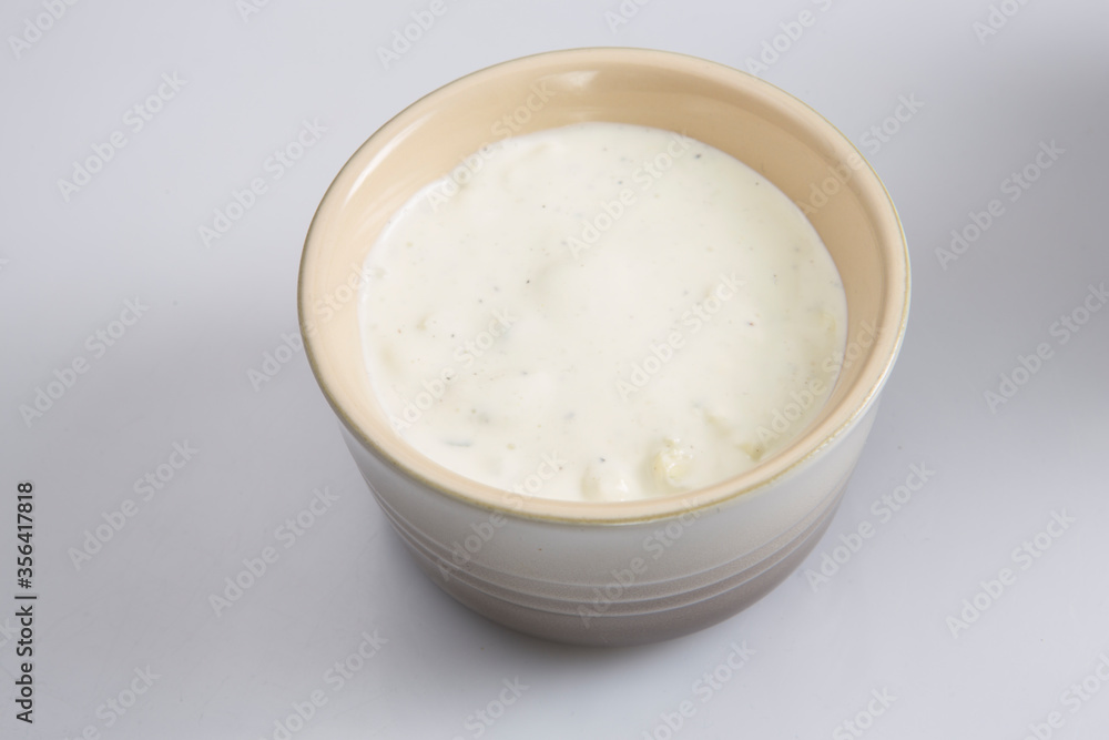 close up isolated top view shot of a brown beige bowl filled with a delicious blue cheese dipping sauce on a white background close up isolated top view shot of a brown beige bowl filled with a delicious blue cheese dipping sauce on a white background