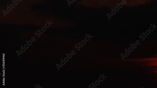 Sunset clouds darken to totally dark night. Timelapse background.