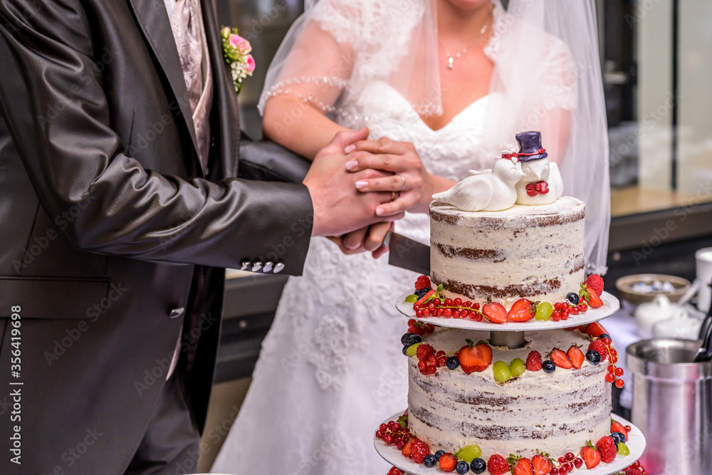 Groom and bride marriage Cutting the delicious fruity Wedding Cake together colorful fruits Groom and bride marriage Cutting the delicious fruity Wedding Cake together colorful fruits