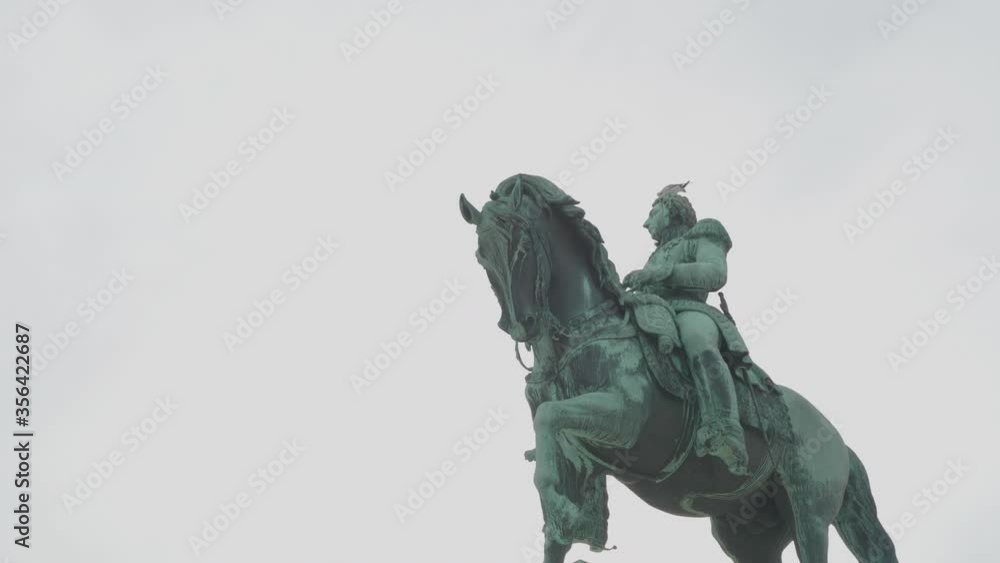 Handheld track shot of Karl Johan statue in front of Royal Palace building on overcast day, in Oslo Norway Handheld track shot of Karl Johan statue in front of Royal Palace building on overcast day, in Oslo Norway
