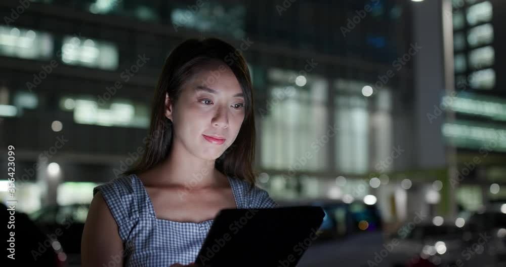 Businesswoman work on tablet computer at night Businesswoman work on tablet computer at night