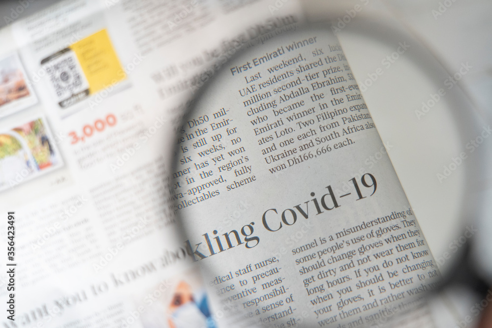 Covid 19 Article On A Newspaper Through A Magnifying Glass Covid 19 Pandemic Headlines Newspaper Stock Photo Adobe Stock