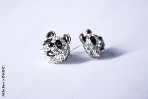 Silver earrings panda-shaped. jewelry and accessories concept. Isolated, copy space. Macro Shot. High quality photo