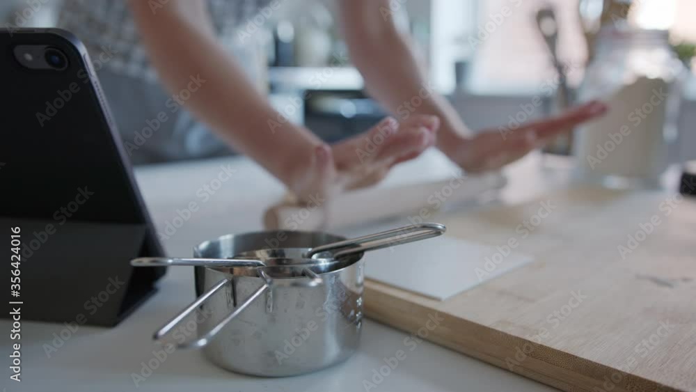Out of Focus blurry, Anonymous person using a rolling pin to Roll out Dough at Home. Making Pasta. Out of Focus blurry, Anonymous person using a rolling pin to Roll out Dough at Home. Making Pasta.
