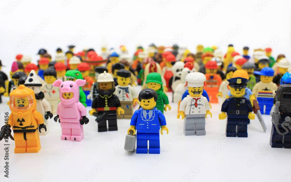 Fototapeta premium HONG KONG,MARCH 1: a business man stand alone in front of different type of people in the human society