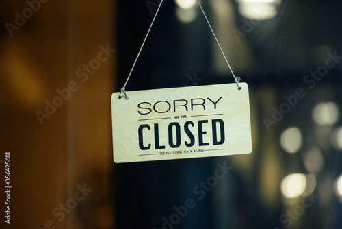 Obraz na płótnie sorry we are closed sign hanging outside a restaurant, store, office or other