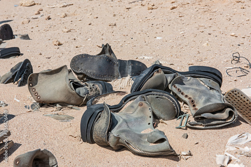 Old military army boots abandoned in remote african desert