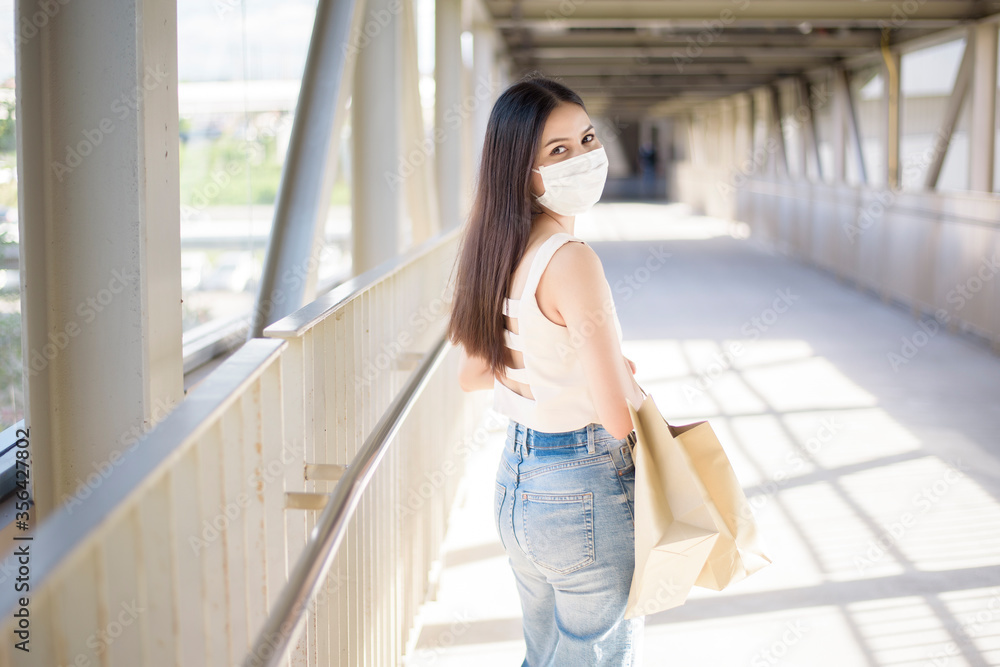 Young woman with face mask is standing outdoor City