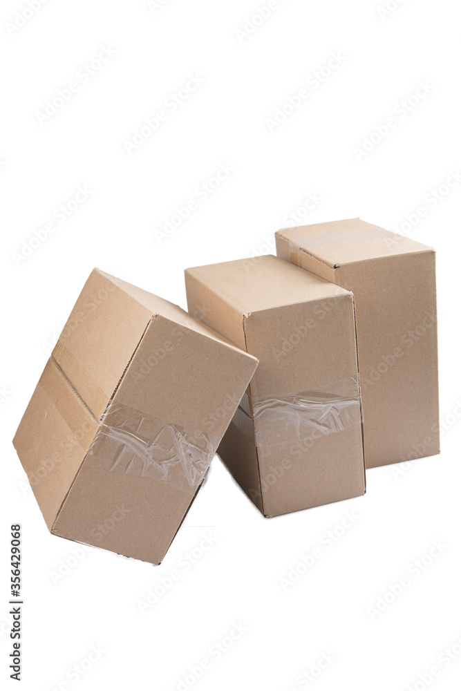 isolated close up shot of three stacked closed rectangular blank brown carton cardboard boxes on a white background isolated close up shot of three stacked closed rectangular blank brown carton cardboard boxes on a white background