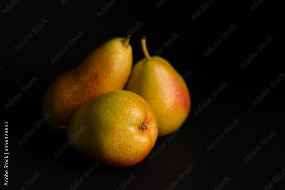 Three pears over a black background Three pears over a black background