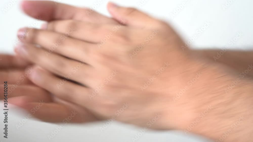 CLOSE UP shot of a man using a hand sanitizer to sanitize hands. CLOSE UP shot of a man using a hand sanitizer to sanitize hands.