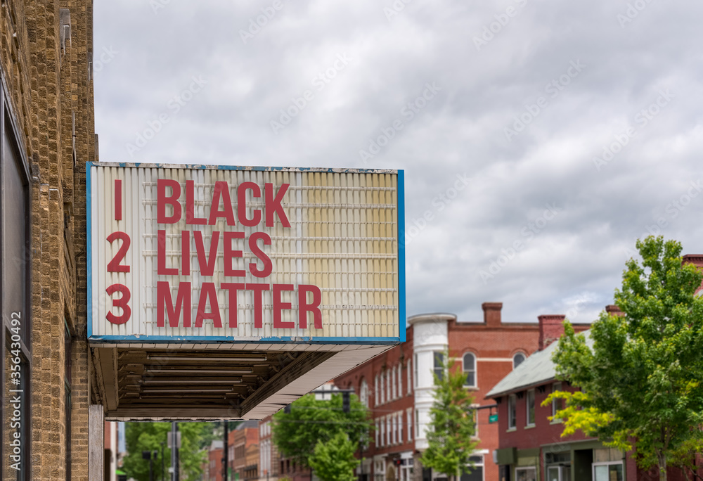 Mockup of movie cinema billboard with message of Black Lives Matter on the marquee in downtown street