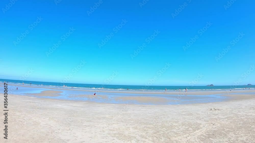 The Video moves from left to the right side of tourists on the Sandy beaches and light waves Background sea at Suan Son Pradipat Beach , Prachuap Khiri Khan in Thailand. February 16, 2020 The Video moves from left to the right side of tourists on the Sandy beaches and light waves Background sea at Suan Son Pradipat Beach , Prachuap Khiri Khan in Thailand. February 16, 2020