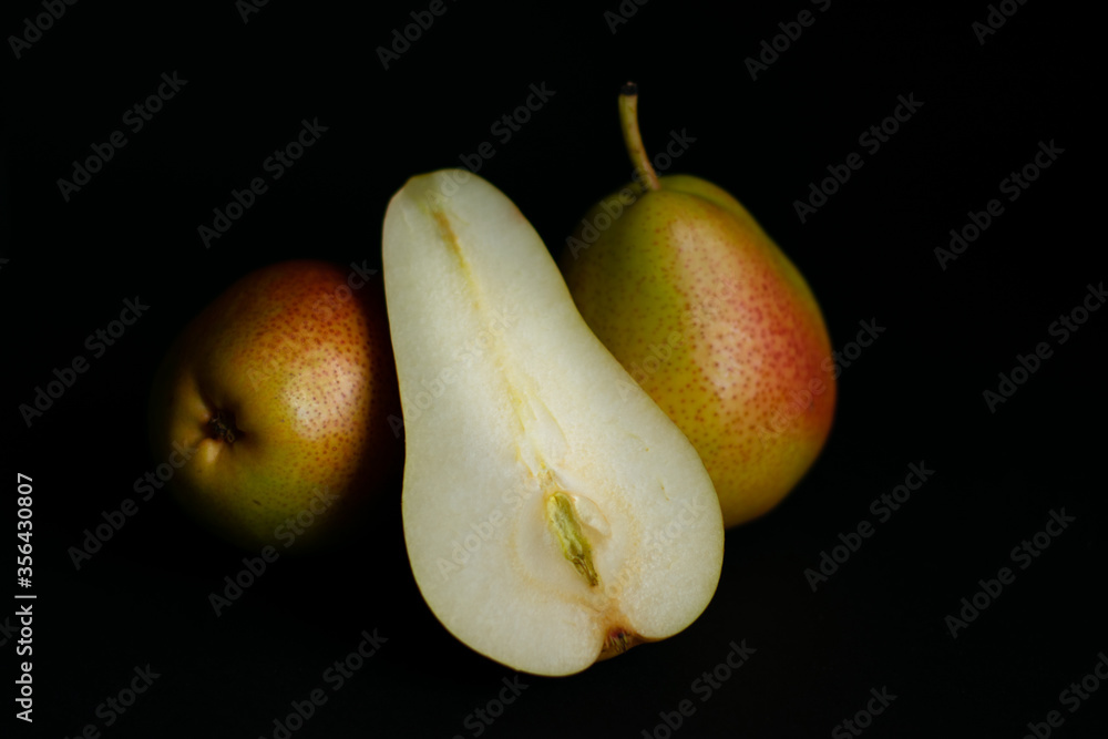 Two pears and half on black background Two pears and half on black background