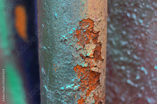 The pipe is painted with fresh spray paint on old peeling paint. The multi-colored futuristic photo was shot close-up for your progressive street design.