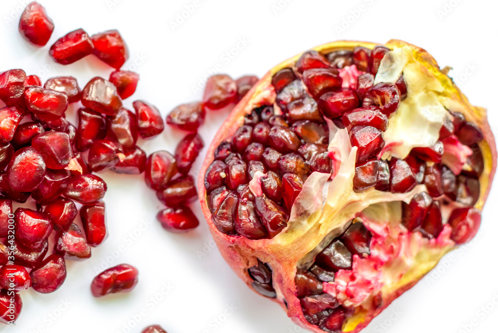 Ripe and juicy pomegranate cut on a white background Ripe and juicy pomegranate cut on a white background