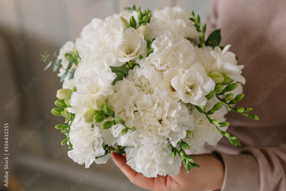 Beautiful girl’s bouquet in the hands of carnations and other flowers Beautiful girl’s bouquet in the hands of carnations and other flowers