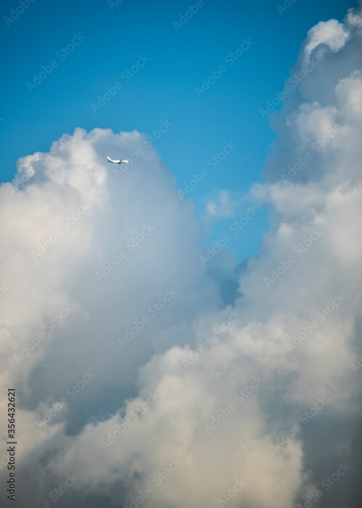 Aeroplane crossing thick clouds in Delhi sky, India Aeroplane crossing thick clouds in Delhi sky, India