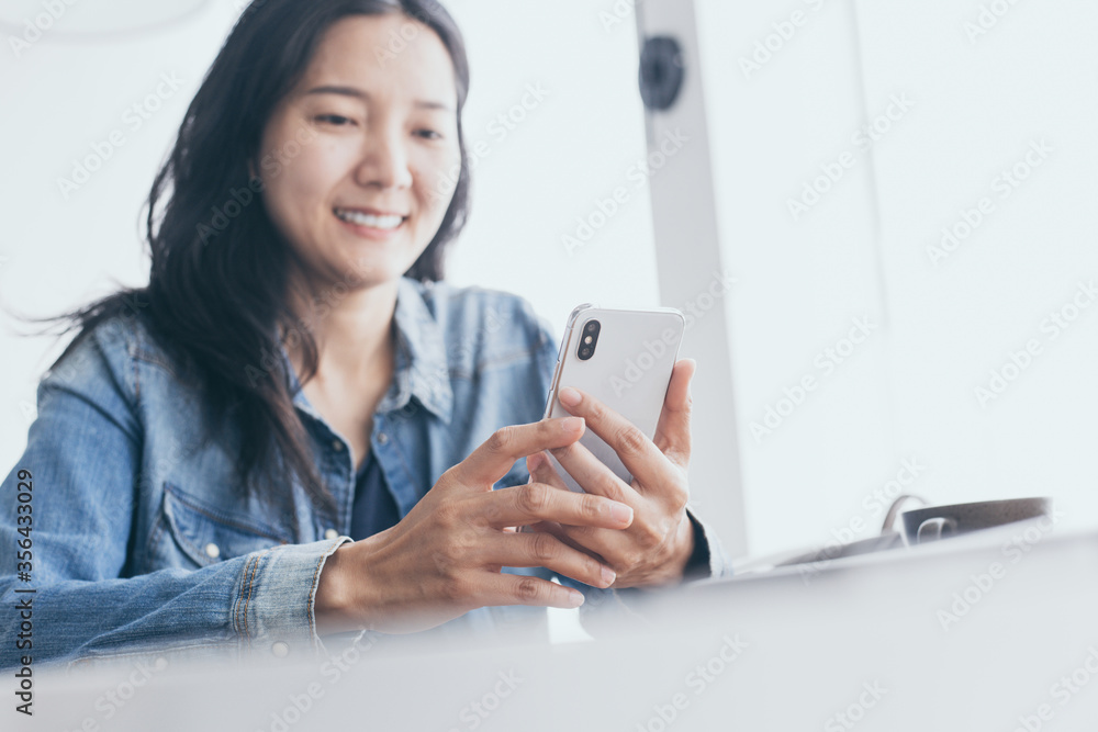 using cell phone.hand woman holding texting message on screen mobile chatting,search internet information sitting in office.technology device contact communication connecting people concept using cell phone.hand woman holding texting message on screen mobile chatting,search internet information sitting in office.technology device contact communication connecting people concept