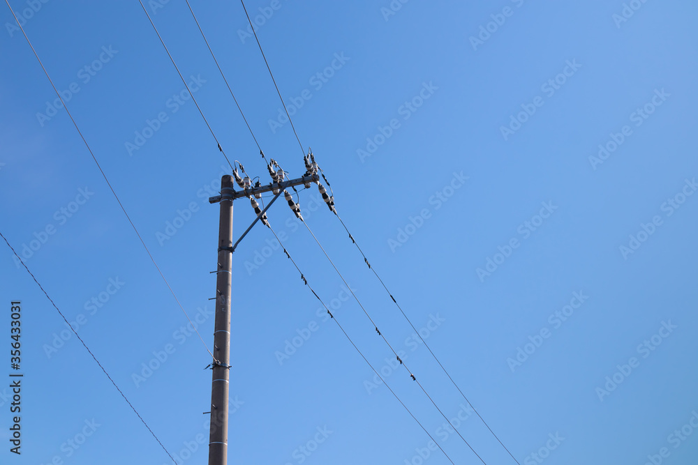 Steel electric tower and cables with blue sky background in JAPAN. Steel electric tower and cables with blue sky background in JAPAN.