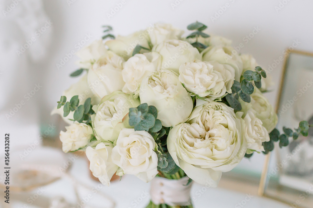 Amazing bouquet of white peonies for the bride for the wedding in the hands of a girl