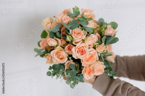 Amazing bouquet of roses in a girl's hands for a birthday
