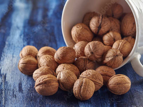 Walnuts lie on a colored wooden background.Nuts are good for your health.Vegan