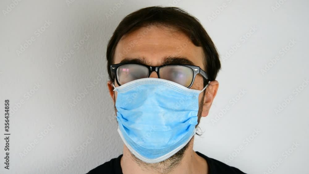Man with surgical mask with fogged glasses Man with surgical mask with fogged glasses