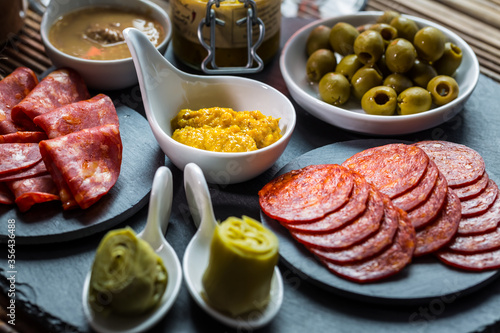 Assortment of tapas and antipasti on black background