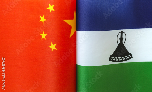 fragments of national flags of China and the Kingdom of Lesotho close up photo